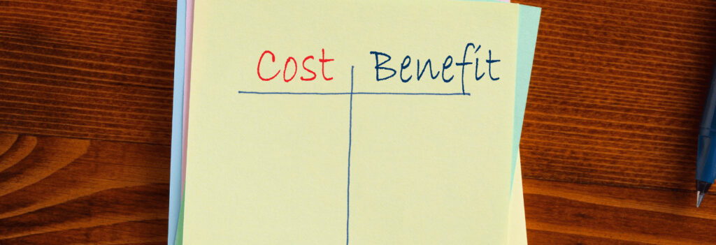 A stack of sticky notes with a chart for conducting a cost benefit analysis