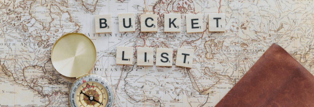 A map with a compass and letter tiles spelling, "bucket list", representing one of the best employee benefits