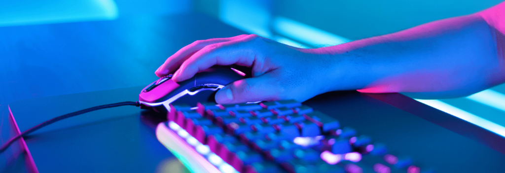 A brightly lit mouse and keyboard for a desktop computer, sitting on a table