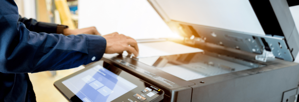 A person printing a document, one of the most important parts of computer literacy