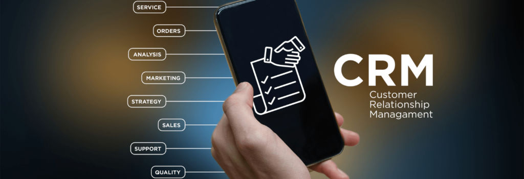 A person holding a phone screen depicting CRM software for small business management